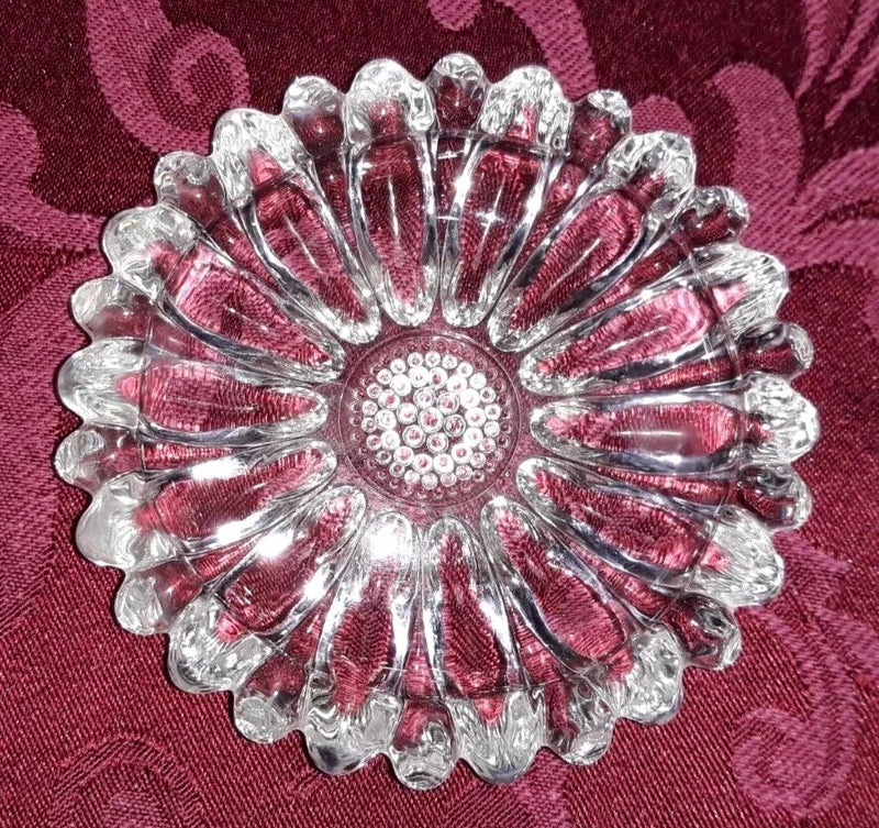 Clear glass sunflower-shaped sunburst trinket dish with scalloped petals