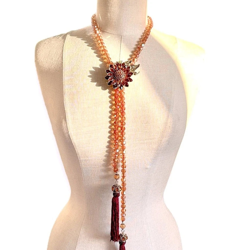 Boho lariat necklace with amber bead strand and red-gold sunflower crystal pendant