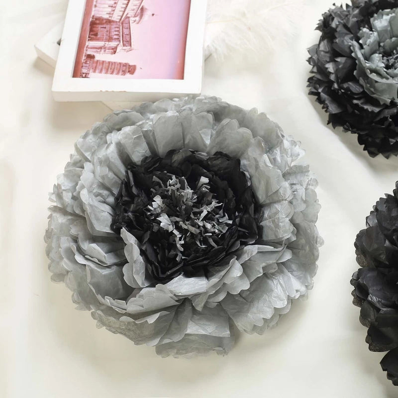 Charcoal grey tissue paper flower backdrop, layered rosette with dark center detail