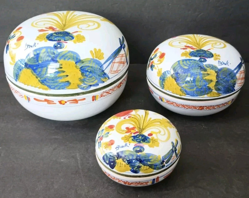 Set of 3 nested ceramic covered bowls with blue floral bird lids and painted trim