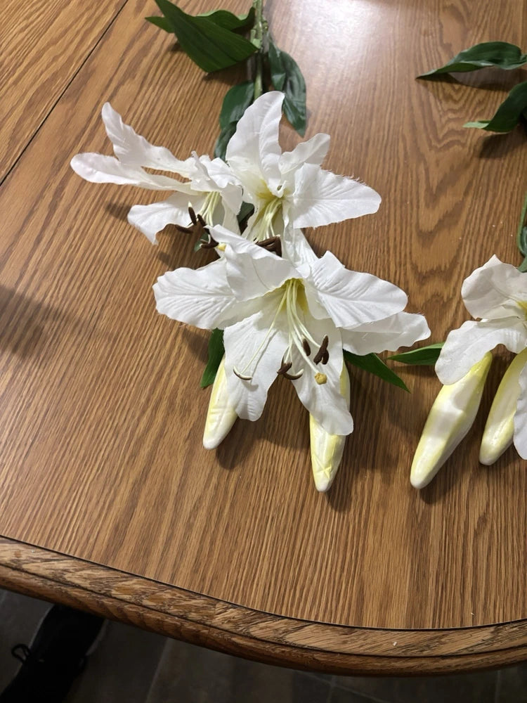 White silk tiger lily flower with green leaves and long stem