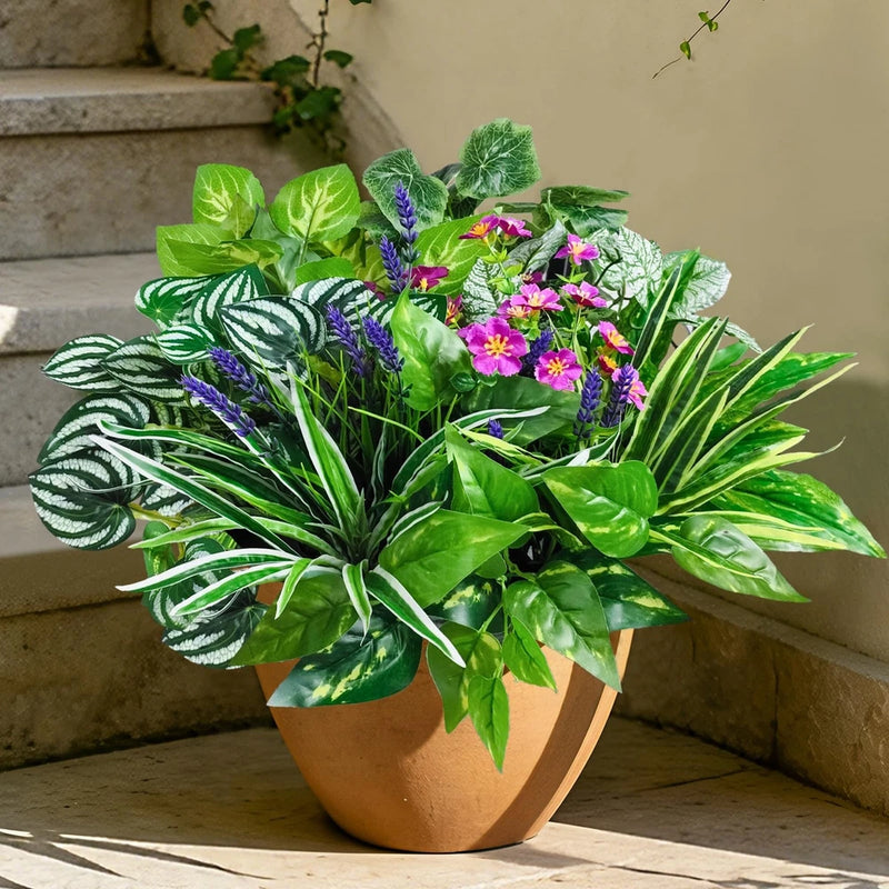 Artificial potted plant with green leaves and purple and pink faux flowers