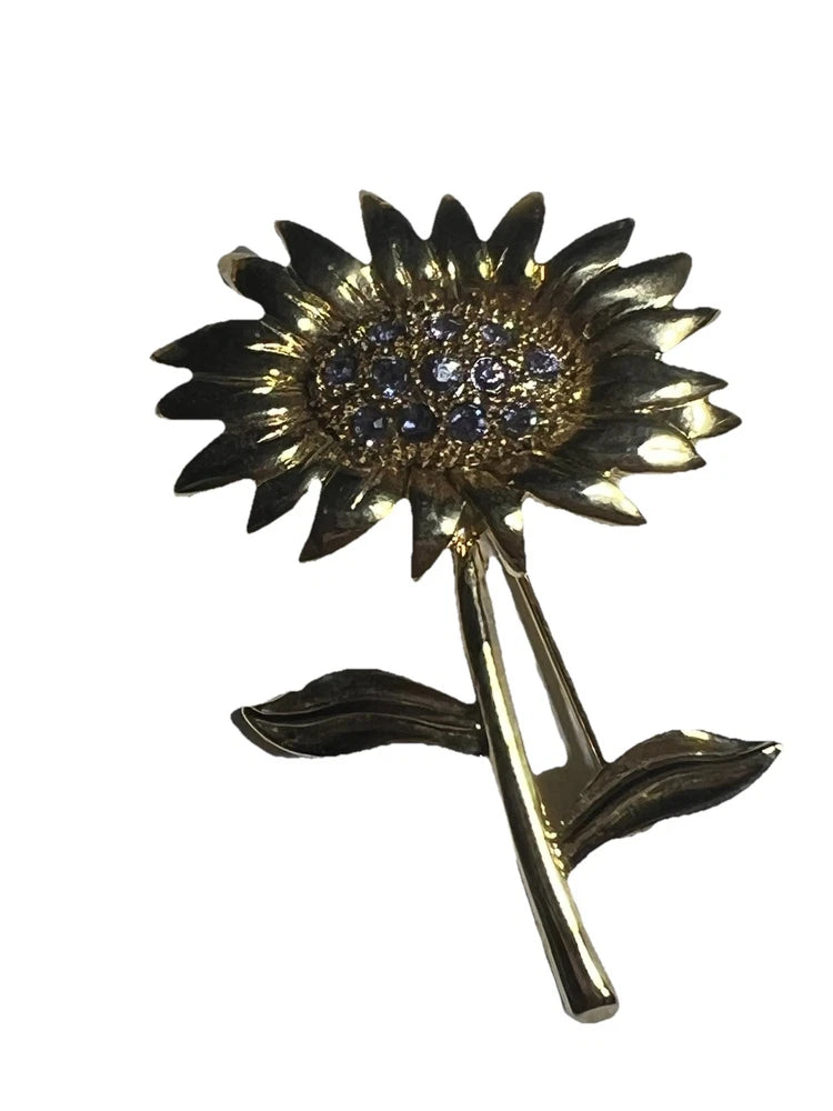 Gold-tone sunflower brooch pin with rhinestone center and leaf accents
