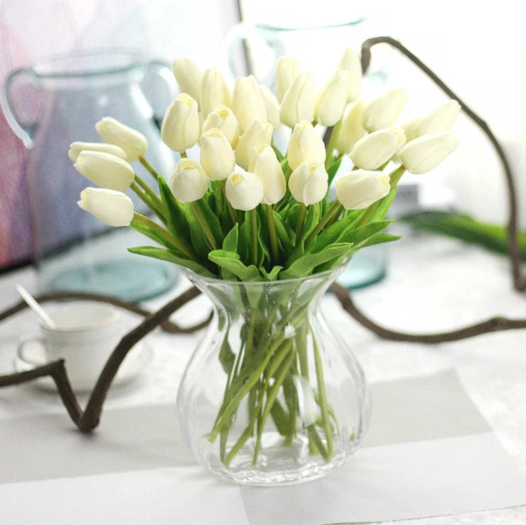 Set of 10 artificial tulip stems with cream-white flowers and green leaves in clear vase