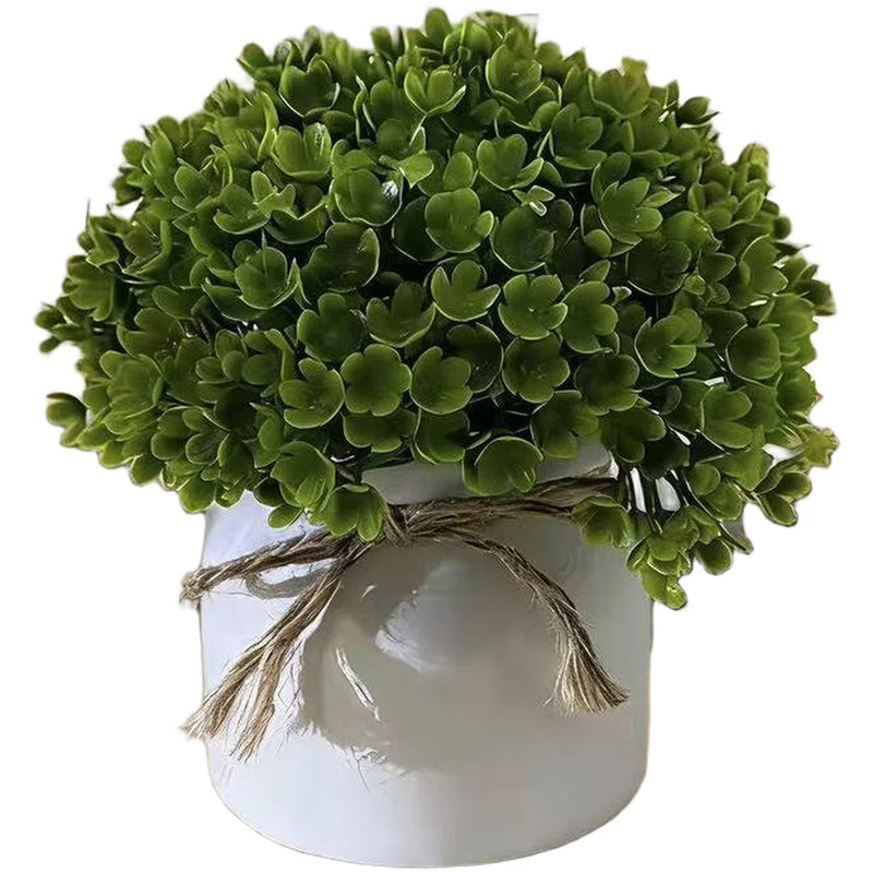 Artificial faux potted plant with dense green plastic foliage in white round pot