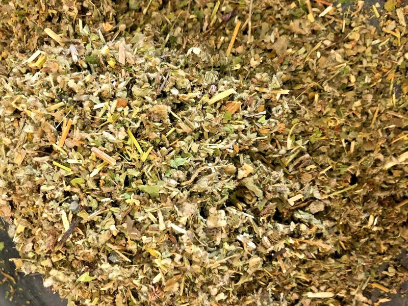 Dried herb and flower mix with chopped leaves and petals in tan and green