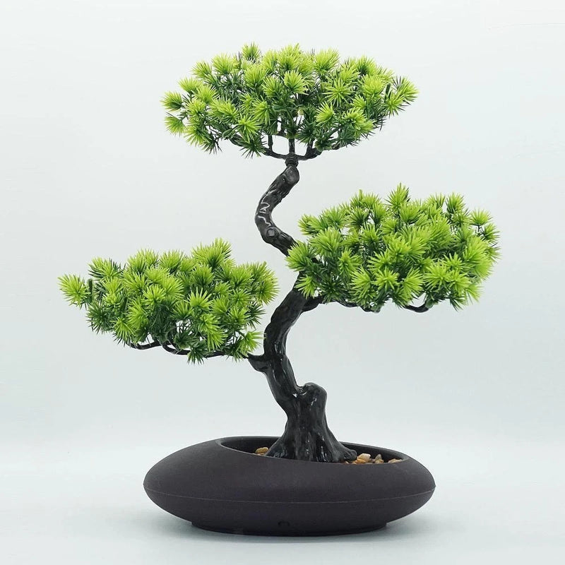 Small artificial bonsai pine tree ornament with green needles in dark bowl pot