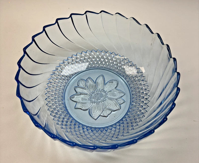 Blue pressed glass serving bowl with scalloped rim and raised sunflower medallion