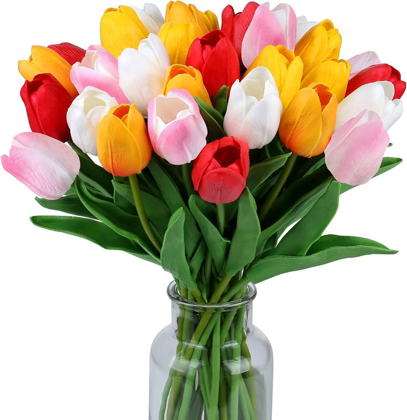 Artificial tulip bouquet with red, yellow, white, and pink blooms in clear glass vase