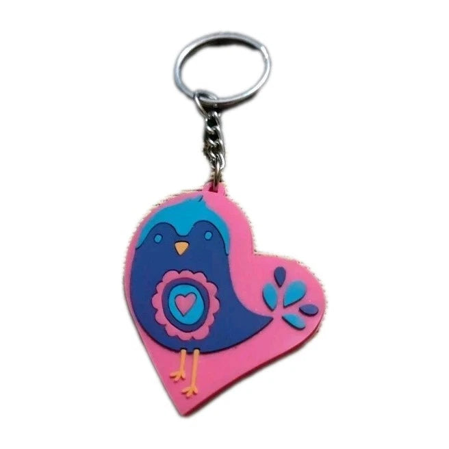 Pink heart-shaped keychain with blue chick holding a heart charm and small flower