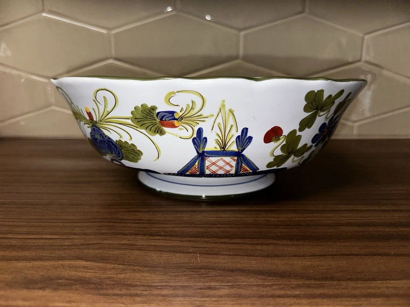 Blue and white footed serving bowl with floral garland pattern and green leaves