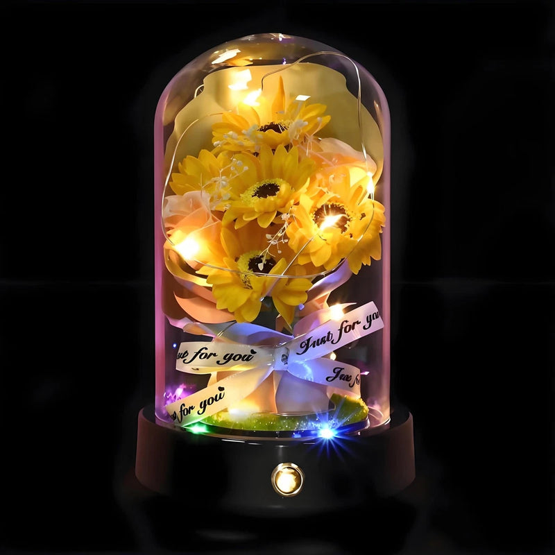 Glass dome sunflower nightstand lamp with glowing LEDs and artificial yellow flowers on black base