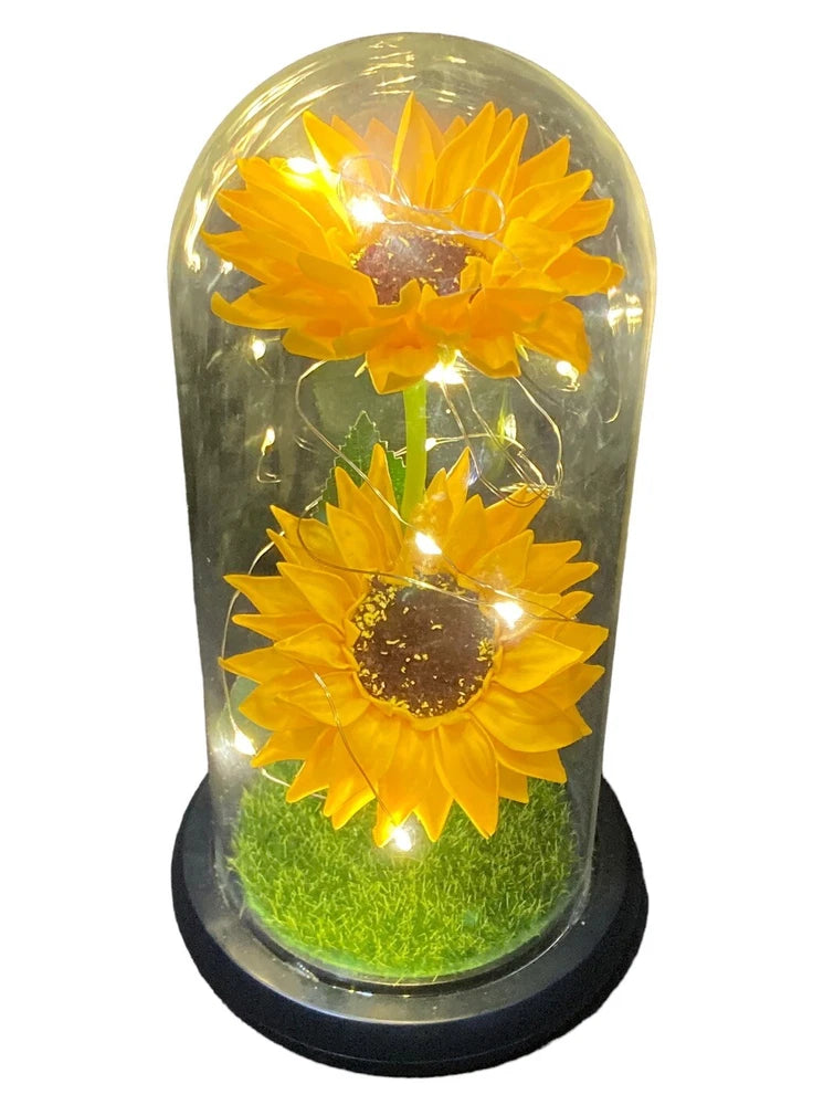 Lighted sunflower home decor with two yellow blooms under clear dome and green moss