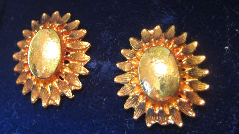 Gold-tone sunflower stud earrings with oval center and starburst petal detailing