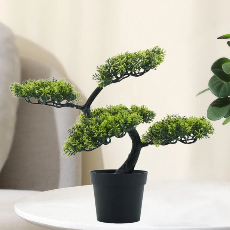 Artificial bonsai tree with bright green foliage in a black square pot