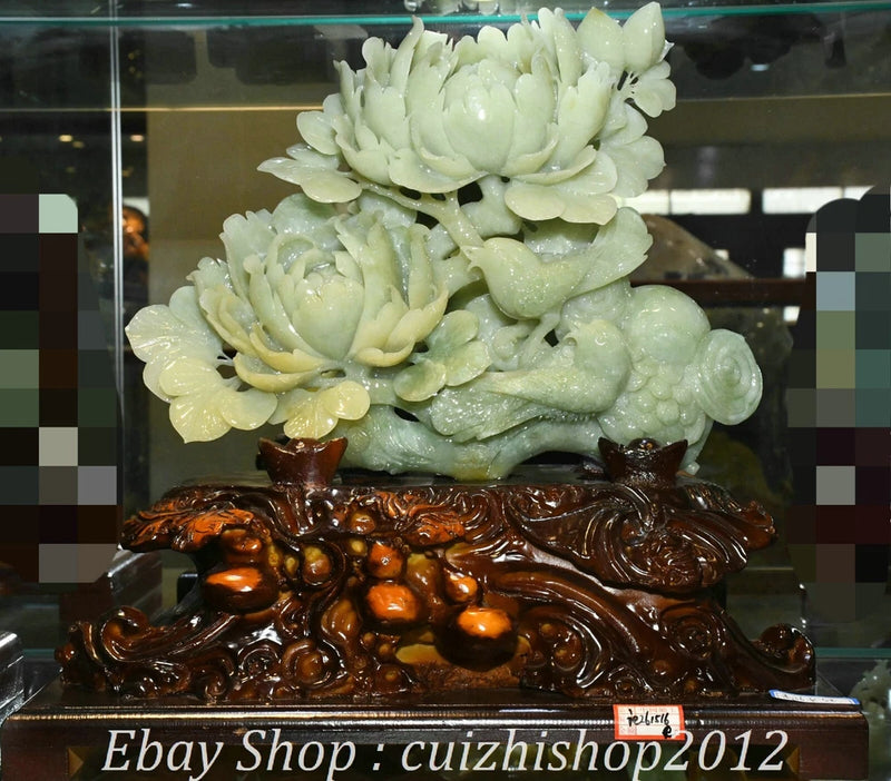 Green jade-style bird and peony flower carving statue on detailed dark base