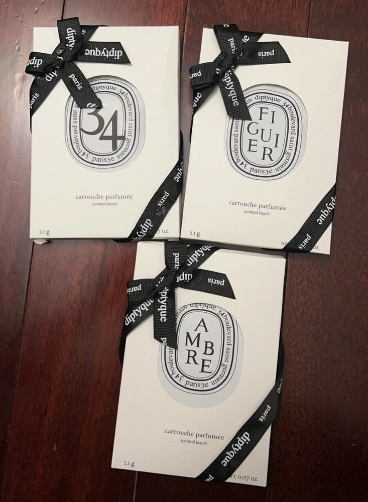 Diptyque car fragrance insert, sealed paper sachet with circular scent label (3-pack)