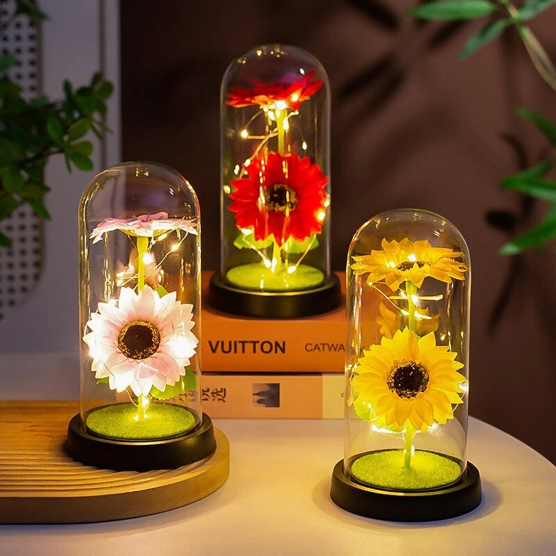 Sunflower LED light ornament with glowing flowers under clear glass dome on base