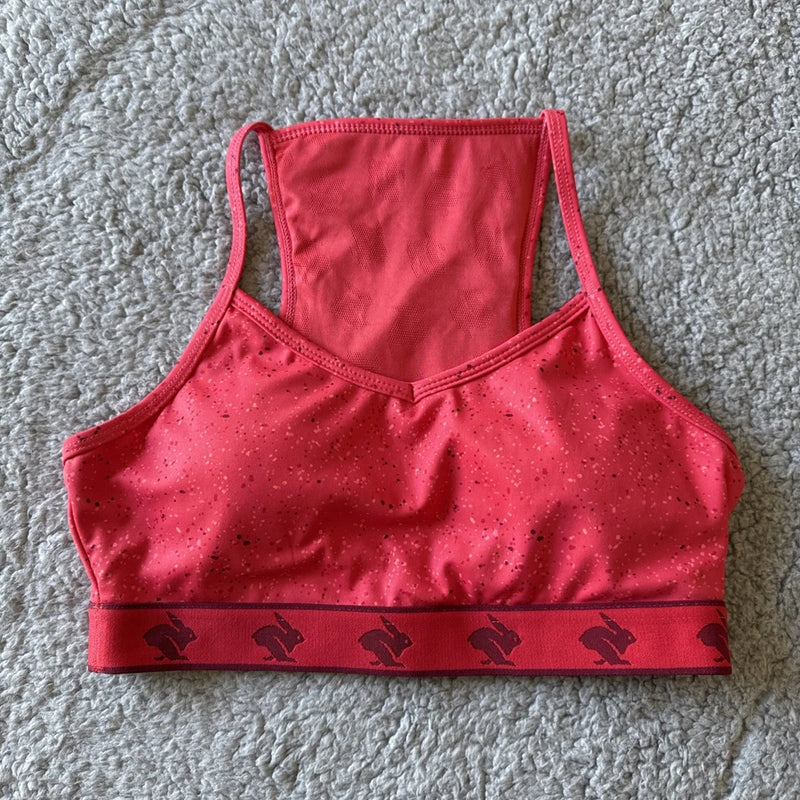 Women's strappy sports bra, hibiscus red with black bunny print waistband