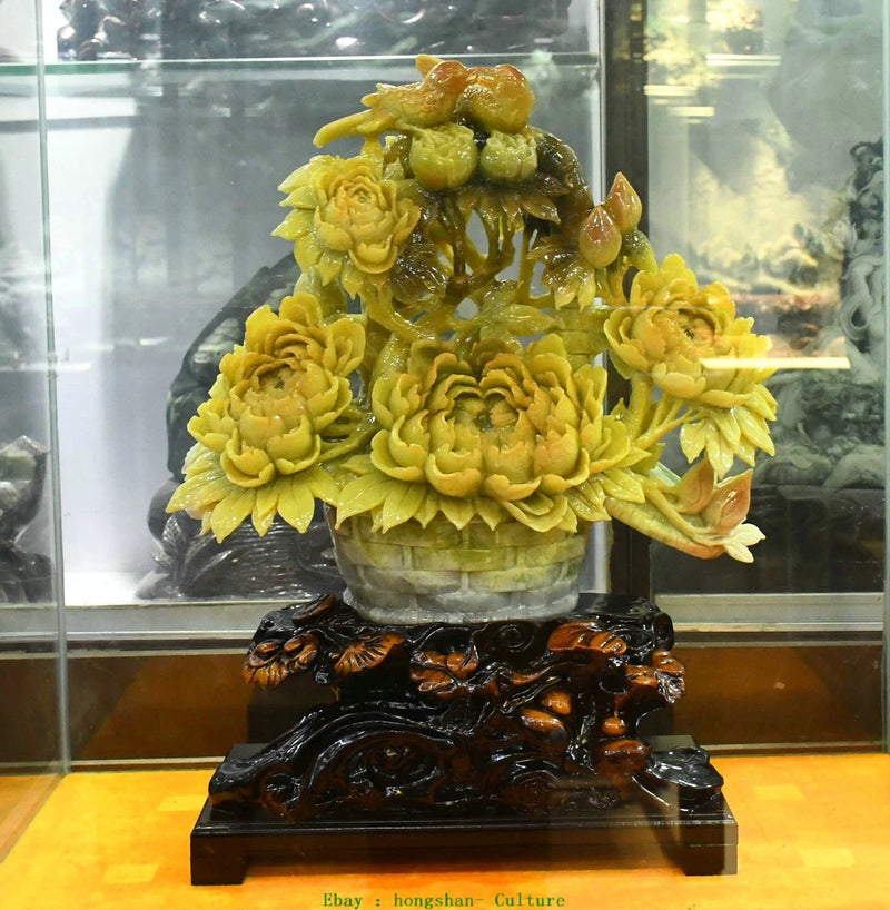Yellow jade-style peony and bird ornament on dark carved base