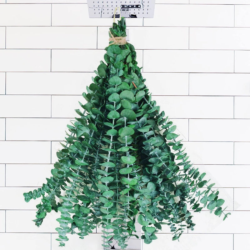 Bundle of dried green eucalyptus stems with small oval leaves for hanging decor