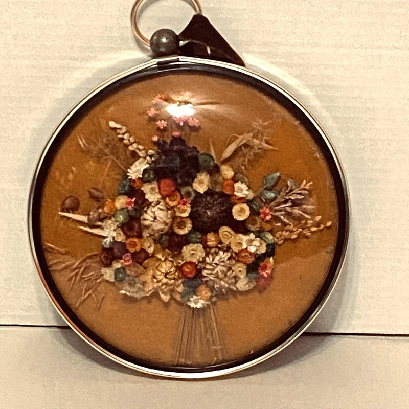 Round convex glass dried flower wall art with silver frame and hanging loop
