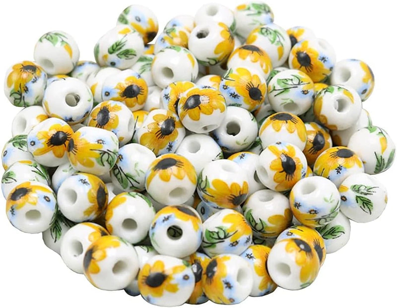 Round ceramic sunflower beads, white with yellow flower prints, center holes