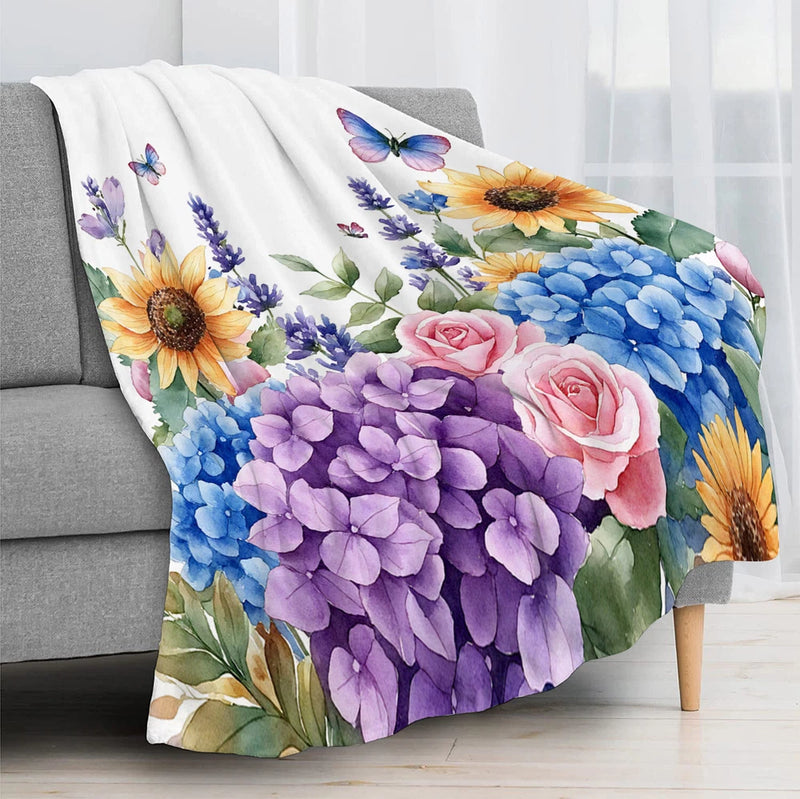 Floral throw blanket with sunflowers, hydrangeas, roses, and butterflies in blue and purple