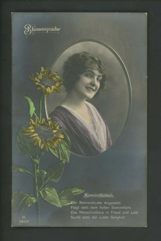 Vintage real photo postcard of a woman holding a sunflower bouquet
