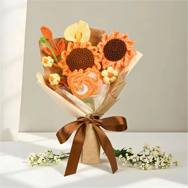 Handmade crochet flower bouquet with orange and cream blooms, dark centers, tied ribbon