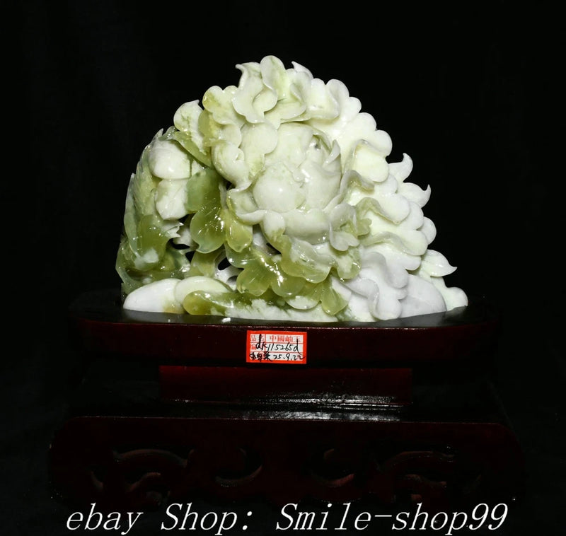 Carved green-and-white jade peony flower sculpture with dark wooden base