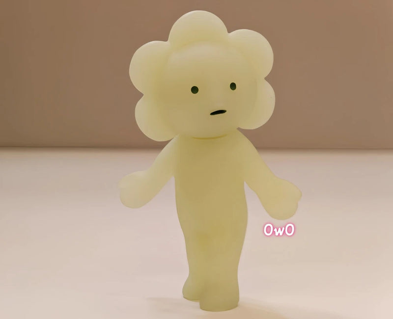 Small yellow flower-head toy figure with round face and arms
