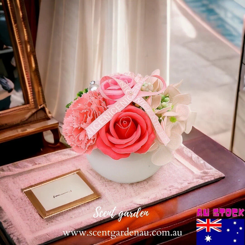 Ceramic pot flower arrangement: pink rose and carnation flowers in a white planter
