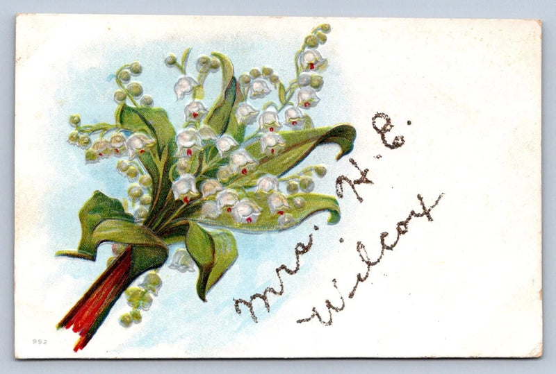 Vintage embossed lily of the valley postcard with white flowers, green leaves, red ribbon, script