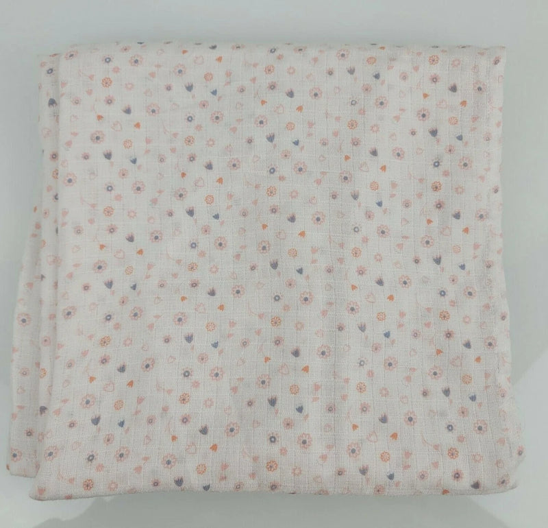 White baby blanket with tiny ditsy floral pattern in pastel blue, pink, and purple, folded