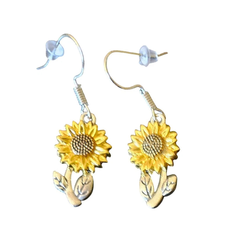 Sunflower dangle earrings with yellow resin flowers and leaf accents, gold-tone hooks