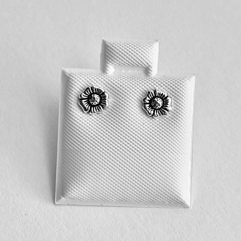 Small silver sunflower stud earrings with dark enamel centers, round posts