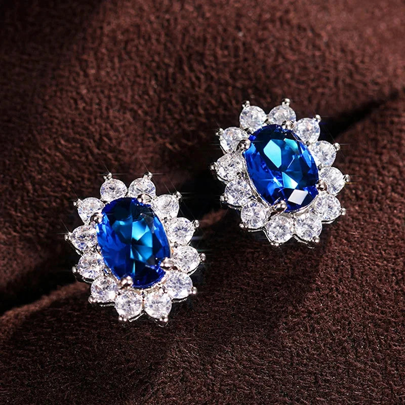 Gold-tone oval blue zircon sunflower stud earrings with clear stone halo