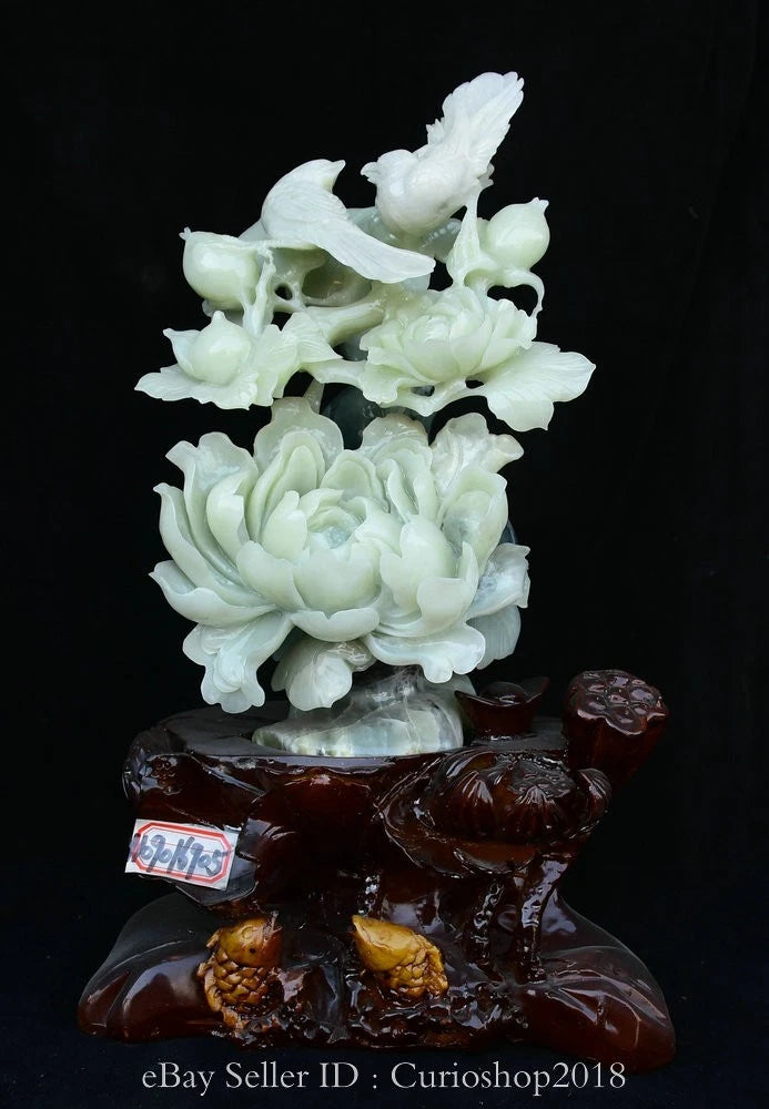 Carved jade peony flower and bird sculpture with dark wood base
