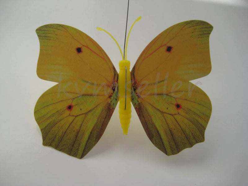 Yellow butterfly garden stake decor with glowing wings and curled antennae