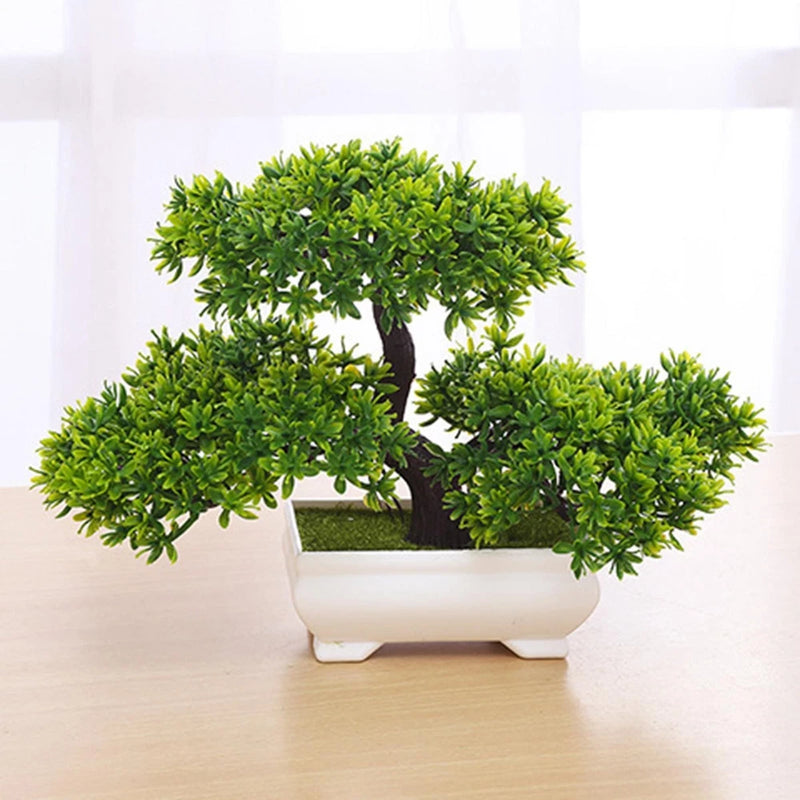 Faux bonsai tree with dense green foliage in a white rectangular pot