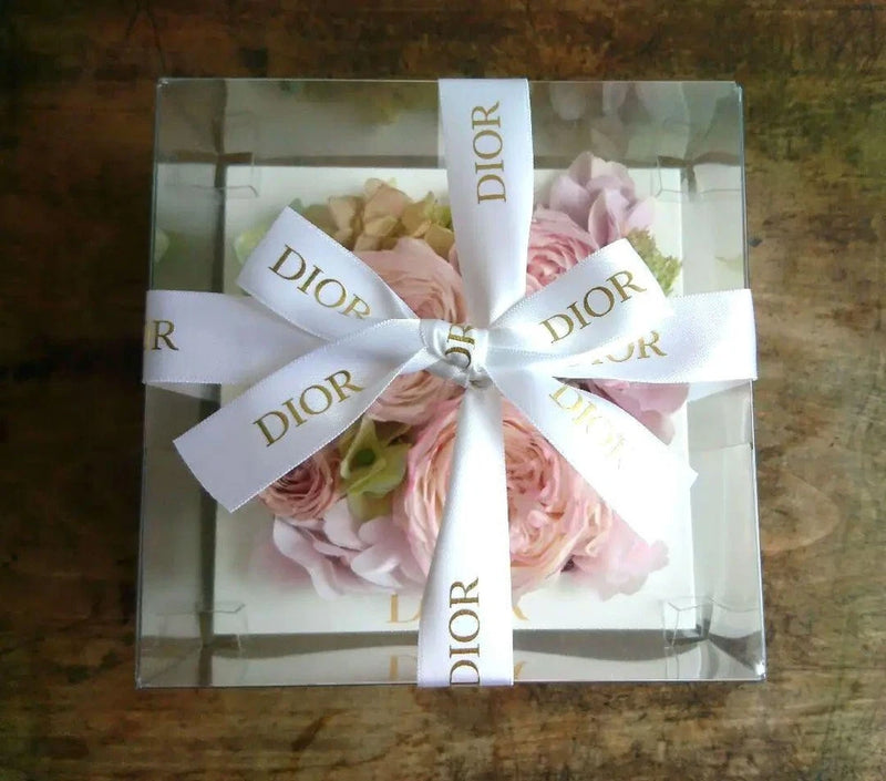 Preserved pink rose arrangement in clear box with Christian Dior ribbon