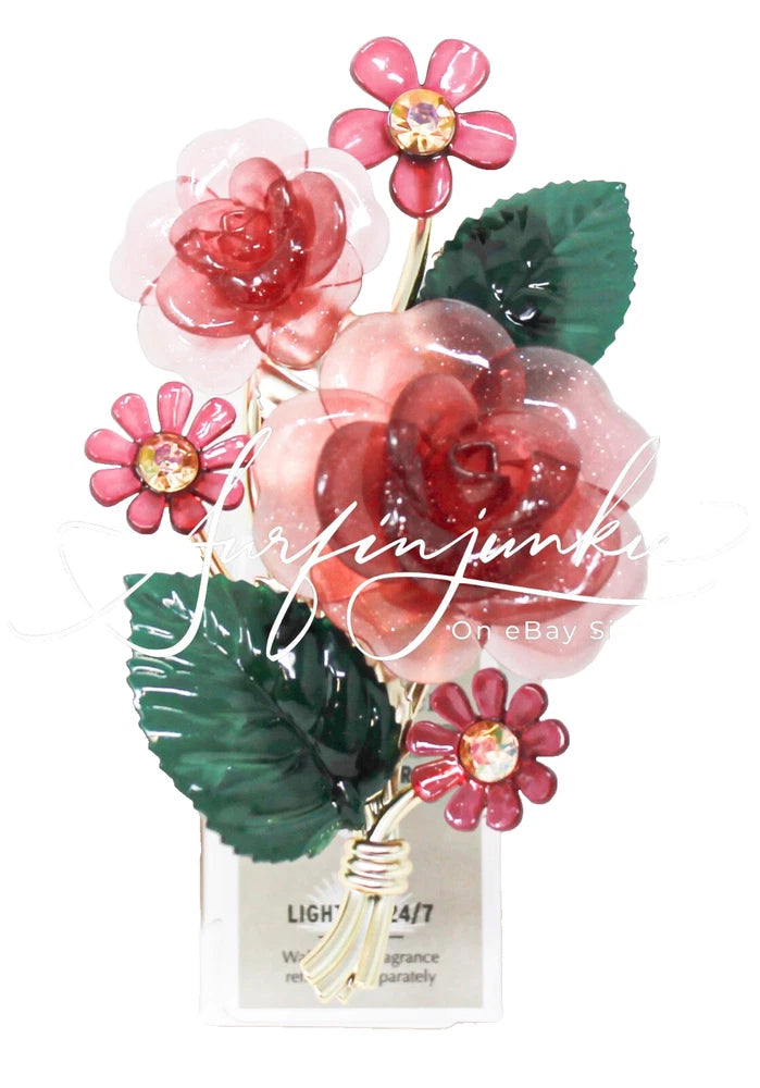 Light-up floral wallflower plug with pink flowers and green leaves on a white base