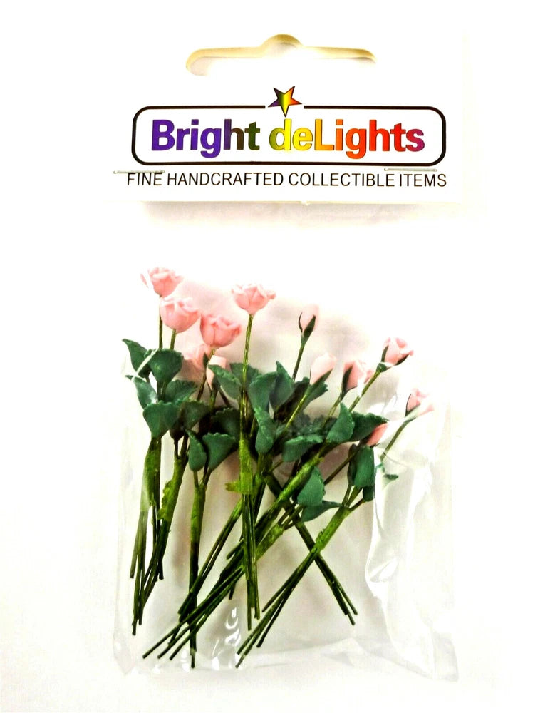 Miniature bouquet with pink roses and rose buds, green leaves, in clear wrap