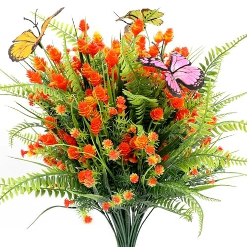 Artificial floral and fern plant bouquet with orange blossoms and butterfly accent