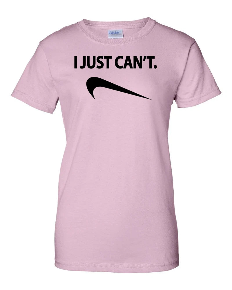 Women's pink graphic t-shirt with 'I JUST CAN'T.' text and swoosh-style logo