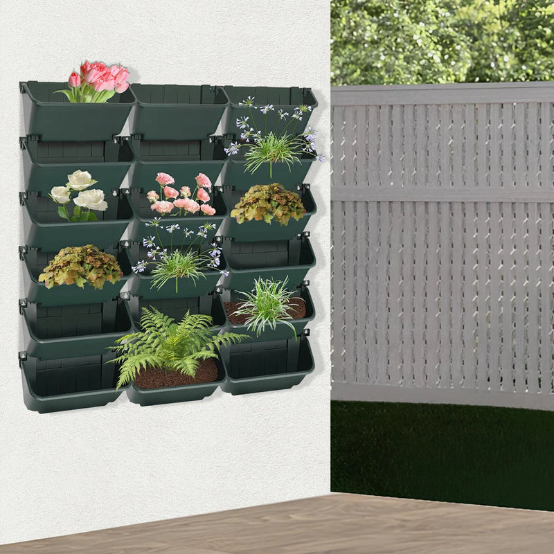 Green 18-cell vertical hanging planter wall organizer with 3-tier row pockets and plants