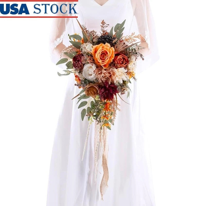 Silk rose bridal bouquet with orange and burgundy faux flowers, greenery, and cascading ribbons