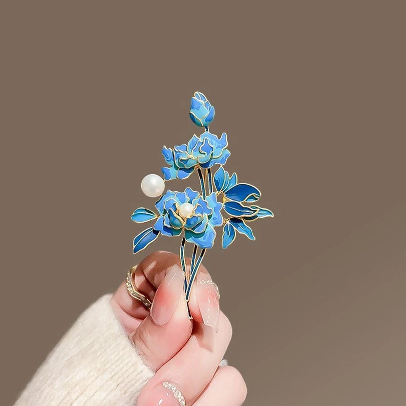 Blue enamel peony flower brooch with white pearl accents and gold-tone stems