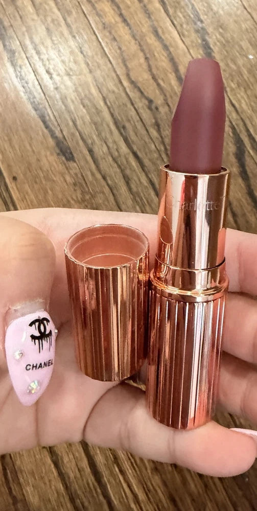 Rose-gold matte lipstick with open tube and mauve lipstick bullet